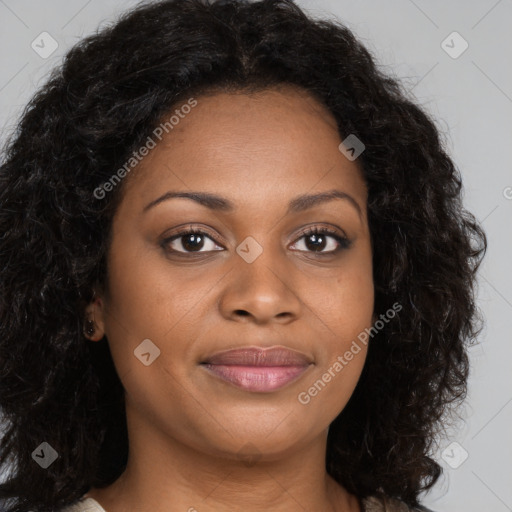 Joyful black young-adult female with long  brown hair and brown eyes