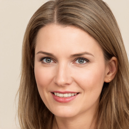 Joyful white young-adult female with long  brown hair and brown eyes