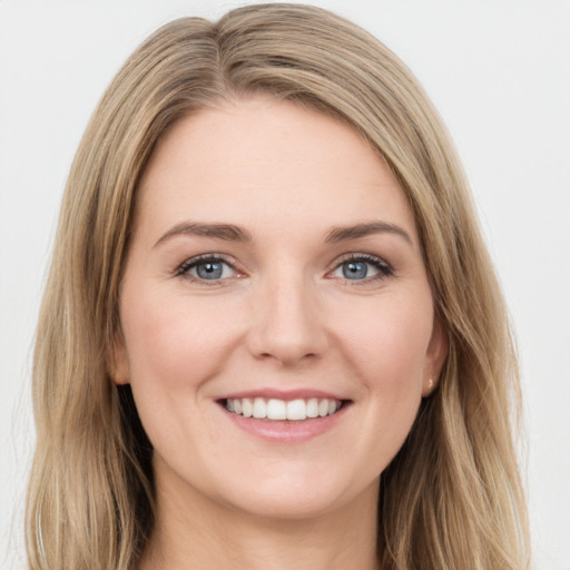 Joyful white young-adult female with long  brown hair and green eyes