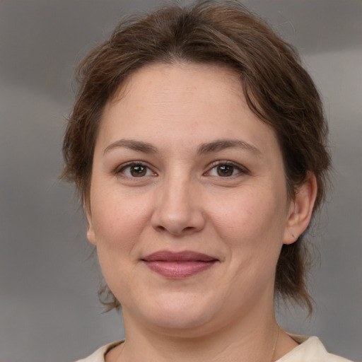 Joyful white adult female with medium  brown hair and brown eyes