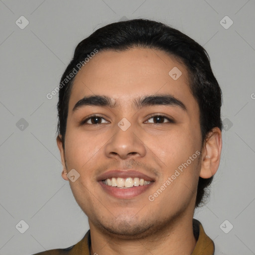 Joyful latino young-adult male with short  black hair and brown eyes