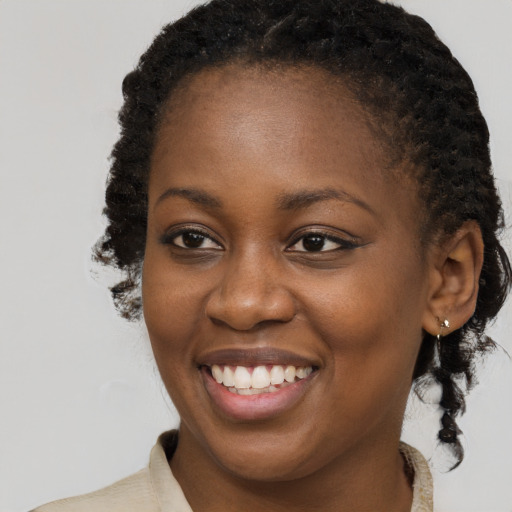 Joyful black young-adult female with medium  brown hair and brown eyes