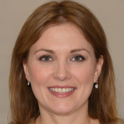 Joyful white young-adult female with medium  brown hair and grey eyes