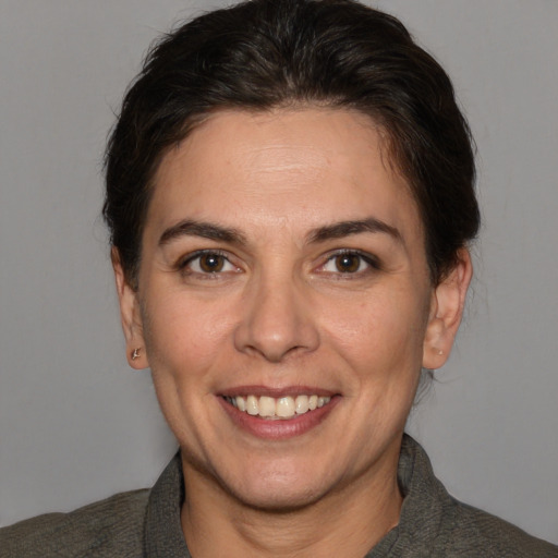 Joyful white adult female with short  brown hair and brown eyes