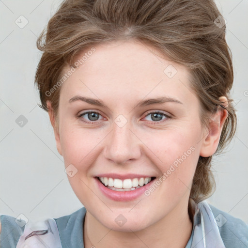 Joyful white young-adult female with medium  brown hair and blue eyes