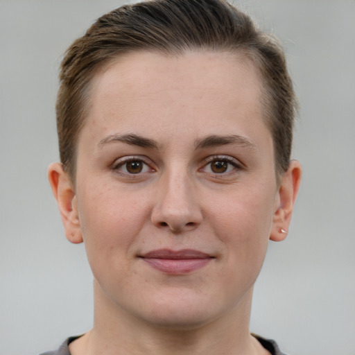 Joyful white young-adult female with short  brown hair and grey eyes