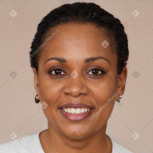 Joyful black young-adult female with short  black hair and brown eyes