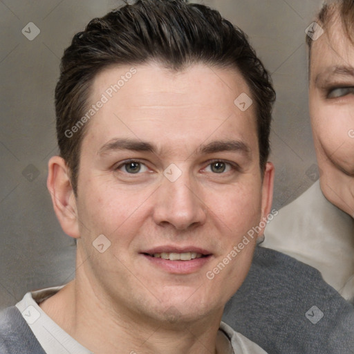 Joyful white adult male with short  brown hair and brown eyes