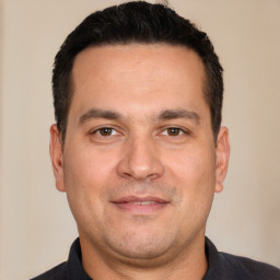 Joyful white adult male with short  black hair and brown eyes