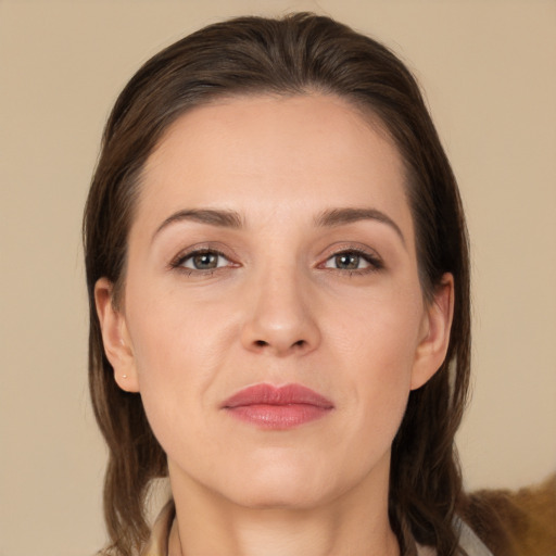 Joyful white adult female with medium  brown hair and brown eyes