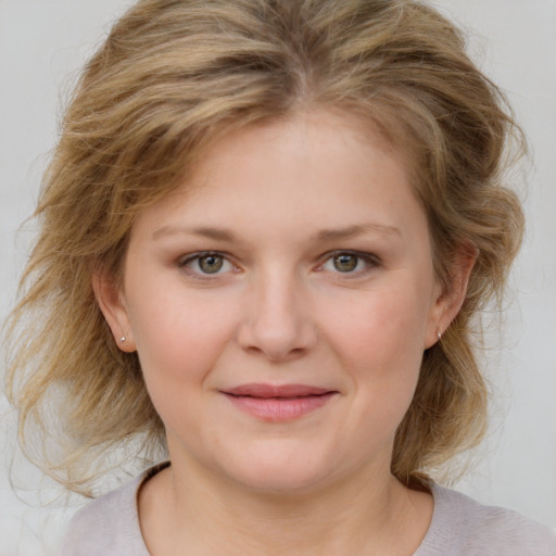 Joyful white young-adult female with medium  brown hair and blue eyes