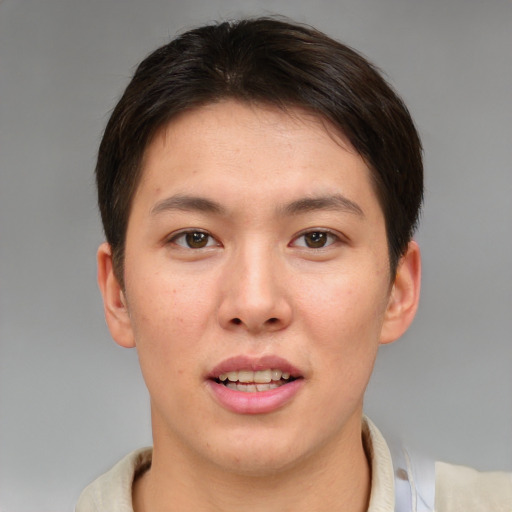 Joyful asian young-adult female with short  brown hair and brown eyes