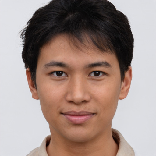 Joyful asian young-adult male with short  brown hair and brown eyes