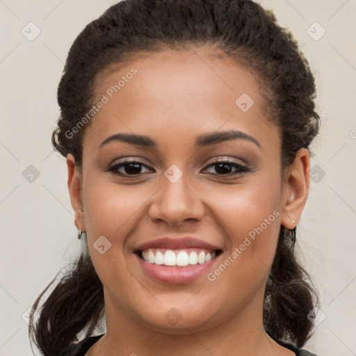 Joyful latino young-adult female with long  brown hair and brown eyes