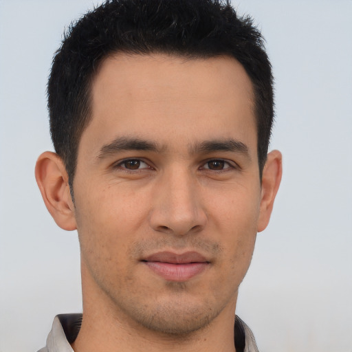 Joyful asian young-adult male with short  brown hair and brown eyes