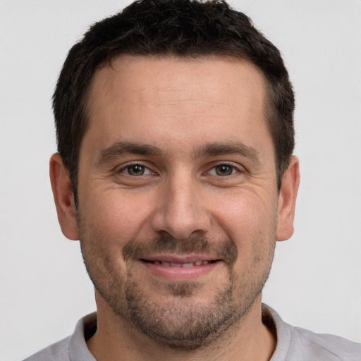 Joyful white adult male with short  brown hair and brown eyes