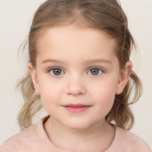 Joyful white child female with medium  brown hair and grey eyes