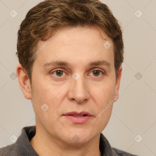 Joyful white adult male with short  brown hair and grey eyes