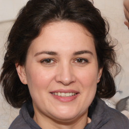 Joyful white adult female with medium  brown hair and brown eyes