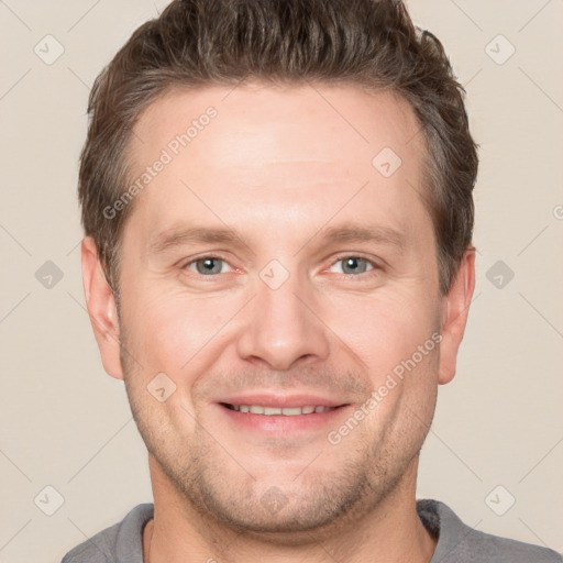 Joyful white adult male with short  brown hair and grey eyes