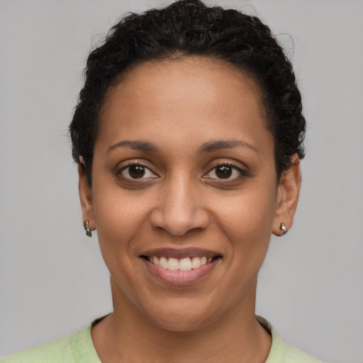 Joyful latino young-adult female with short  brown hair and brown eyes