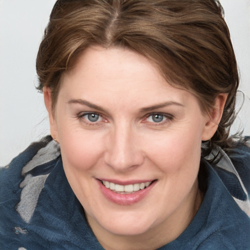 Joyful white young-adult female with medium  brown hair and blue eyes