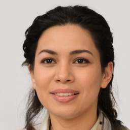 Joyful latino young-adult female with medium  brown hair and brown eyes