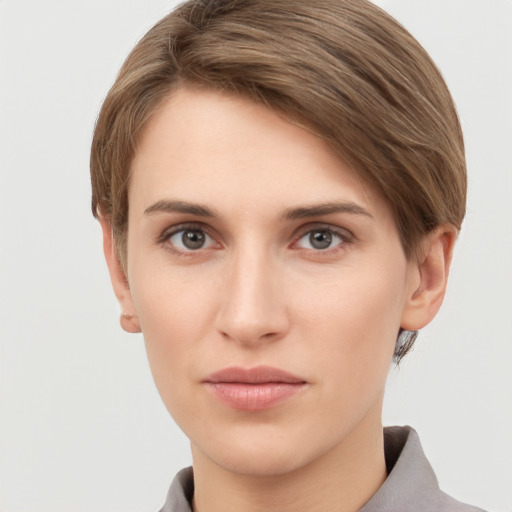 Joyful white young-adult female with short  brown hair and grey eyes