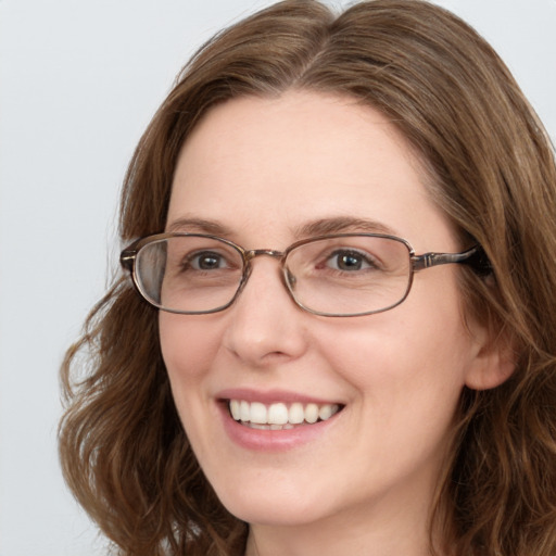 Joyful white young-adult female with long  brown hair and blue eyes