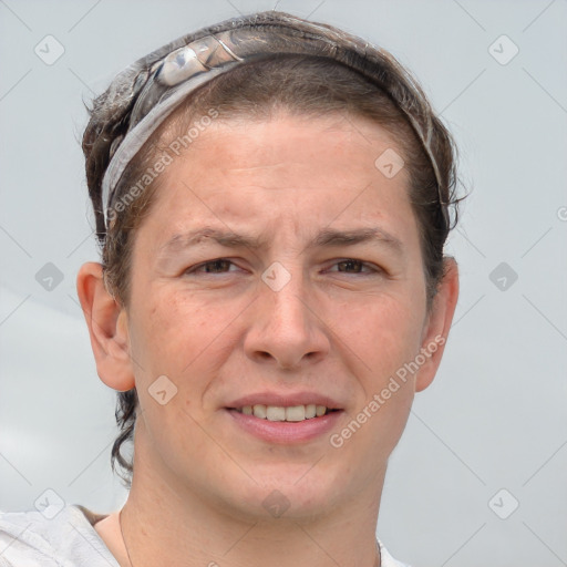 Joyful white adult male with short  brown hair and grey eyes