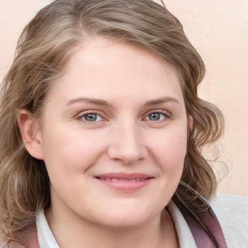 Joyful white young-adult female with medium  brown hair and blue eyes