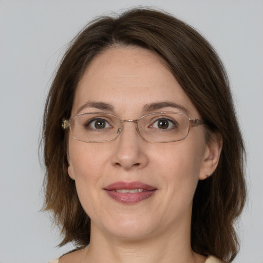 Joyful white adult female with medium  brown hair and brown eyes