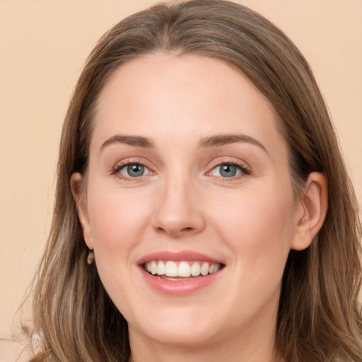 Joyful white young-adult female with long  brown hair and grey eyes