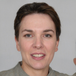 Joyful white adult female with short  brown hair and grey eyes