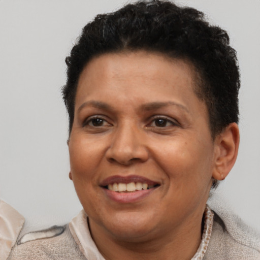 Joyful latino adult female with short  brown hair and brown eyes