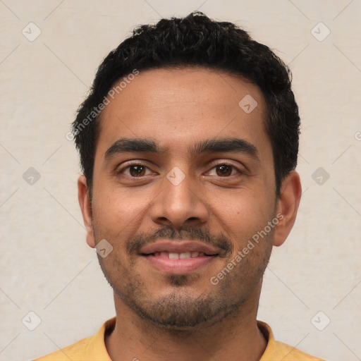 Joyful latino young-adult male with short  black hair and brown eyes