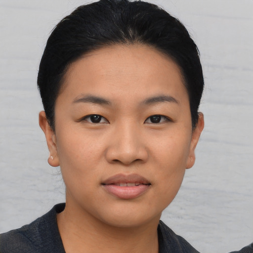 Joyful asian young-adult female with short  black hair and brown eyes