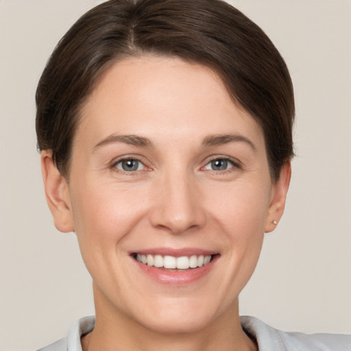 Joyful white young-adult female with short  brown hair and brown eyes