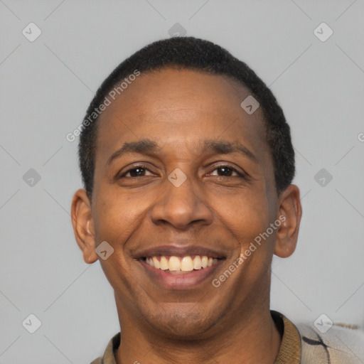Joyful latino adult male with short  black hair and brown eyes
