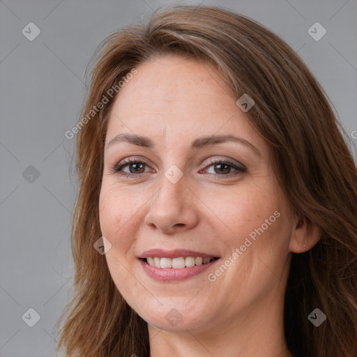 Joyful white adult female with long  brown hair and brown eyes