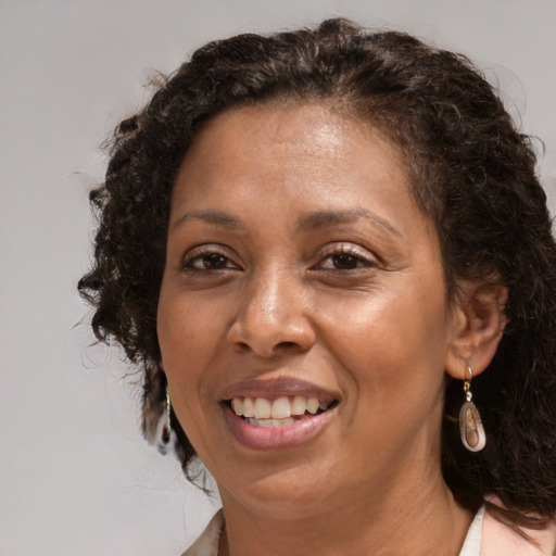 Joyful black adult female with medium  brown hair and brown eyes