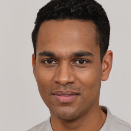 Joyful latino young-adult male with short  black hair and brown eyes