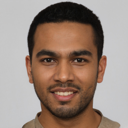 Joyful latino young-adult male with short  black hair and brown eyes
