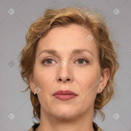 Joyful white adult female with medium  brown hair and grey eyes