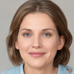 Joyful white young-adult female with medium  brown hair and blue eyes