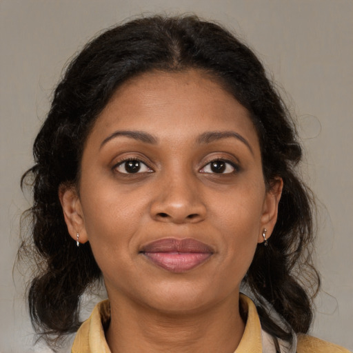 Joyful latino young-adult female with medium  brown hair and brown eyes