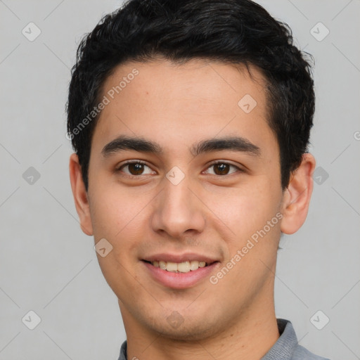 Joyful latino young-adult male with short  black hair and brown eyes