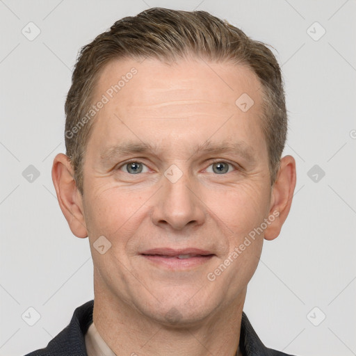 Joyful white adult male with short  brown hair and grey eyes