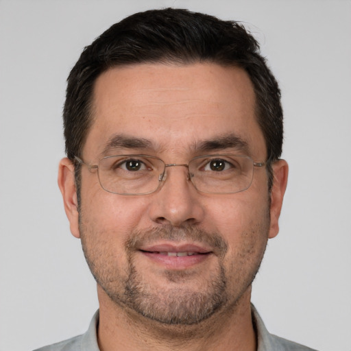 Joyful white adult male with short  brown hair and brown eyes