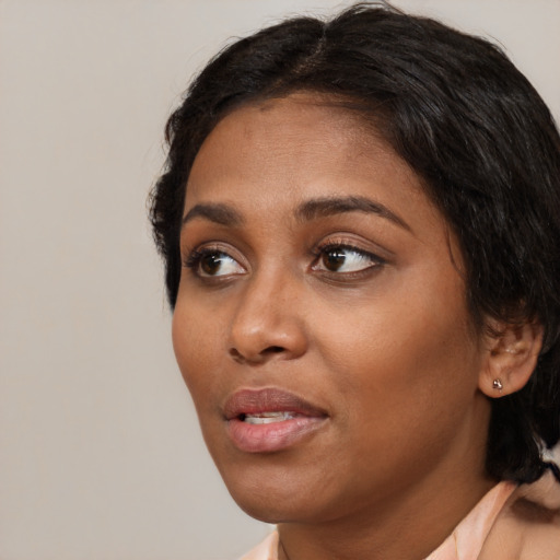 Neutral black young-adult female with medium  black hair and brown eyes